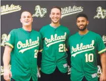  ?? COURTESY THE OAKLAND A’S ?? The A’s unveiled the 50th anniversar­y alternate jerseys for the upcoming season. From left are last year’s rookie stalwarts Matt Olson and Matt Chapman, along with shortstop Marcus Semien.