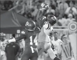  ?? Arkansas Democrat-Gazette/MITCHELL PE MASILUN ?? Little Rock Central’s Mario Thompson (right) makes a catch in front of North Little Rock’s Xavier Roberson during Friday night’s game.