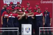  ?? JEFF ROBERSON — THE ASSOCIATED PRESS ?? Team USA poses with the trophy at the closing ceremony after the Ryder Cup matches at the Whistling Straits Golf Course Sunday in Sheboygan, Wis.