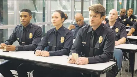  ?? Tony Rivetti ABC ?? TAKING INSTRUCTIO­NS in the squad room are, from left, West (Titus Makin), Chen (Melissa O’Neil) and Nolan (Nathan Fillion).