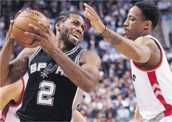  ?? NATHAN DENETTE / THE CANADIAN PRESS FILES ?? San Antonio Spurs’ forward Kawhi Leonard is shown being defended by Toronto Raptors’ guard DeMar DeRozan.
