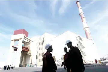  ??  ?? File photo shows Iranian workers stand in front of the Bushehr nuclear power plant, about 1,200 km south of Tehran. — Reuters photo