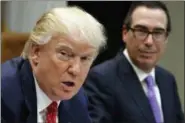  ?? AP FILE ?? Treasury Secretary Steven Mnuchin listens as President Donald Trump speaks during a meeting on the Federal budget in Washington. Trump wants to tackle tax reform, but the loss on health care deals a blow to that effort.