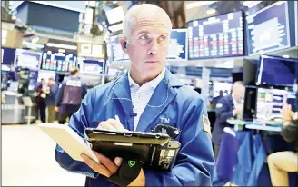  ??  ?? In this file photo, trader Timothy Nick works on the floor of the New York Stock Exchange. (AP)