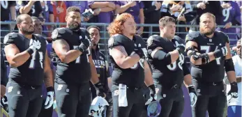  ?? MITCH STRINGER, USA TODAY SPORTS ?? Baltimore players stand for the national anthem before their game against the Steelers.