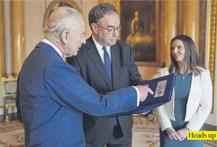  ?? PICTURE: YUI MOK/PA WIRE ?? King Charles is presented with the first bank notes featuring his portrait from the Bank of England Governor Andrew Bailey and Sarah John, the Bank of England’s Chief Cashier, at Buckingham Palace