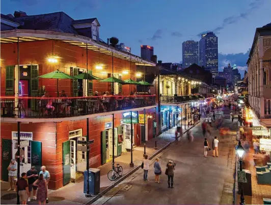  ?? John Coletti / Getty Images ?? Bourbon Street in the French Quarter of New Orleans: Our kickoff stop is in the Crescent City and includes six recipes. These are the flavors you’d seek out if you did have the opportunit­y to travel there.