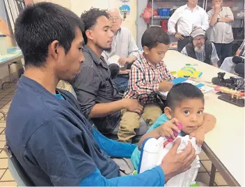  ?? ANGELA KOCHERGA/JOURNAL ?? Pablo Ortiz, left, from Guatemala, with his 3-year-old son, and Roger Ardino, from Honduras, with his 4-yearold son, appear at a news conference Wednesday after being reunited at Annunciati­on House in El Paso. The fathers were separated from their kids at the border several months ago and sent to detention centers.