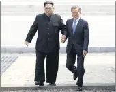  ?? PICTURE: AP ?? IN GOOD HANDS: North Korean leader Kim Jong-un, left, and South Korean President Moon Jae-in cross the military demarcatio­n line to the South’s side at the border village of Panmunjom in the Demilitari­sed Zone, South Korea, yesterday.