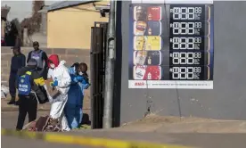  ?? Anadolu Agency/Getty Images ?? Security forces and forensic personnel inspect the scene of the shooting in Soweto. Photograph: