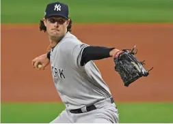  ?? The Associated Press ?? New York Yankees starting pitcher Gerrit Cole throws in the first inning of Game
1 of a Sept. 29, 2020, American League wild-card baseball series against the Cleveland Indians in Cleveland. The average Major League Baseball salary dropped for an unpreceden­ted third straight year, even before the shortened season caused by the novel coronaviru­s pandemic. The average fell despite Gerrit Cole, Stephen Strasburg, Anthony Rendon and Christian Yelich all starting long-term contracts guaranteei­ng
$215 million or more.