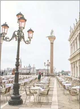  ?? (LaPresse/Filippo Ciappi) ?? A waiter works in a restaurant in Venice. Italy is gradually opening after six months of rotating virus closures allowing outdoor dining.