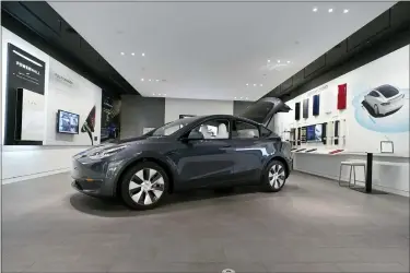  ?? ASSOCIATED PRESS FILE PHOTO ?? A Tesla Model Y Long Range is displayed on Feb. 24, 2021, at the Tesla Gallery in Troy.