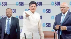  ?? — Debasish Dey ?? Union finance minister Piyush Goyal (centre) is seen along with SBI chairman Rajnish Kumar (left) and PNB Chairman Sunil Mehta (right) ahead of the press conference organised by SBI in Mumbai on Friday.