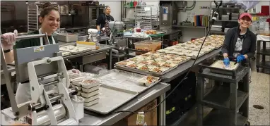  ?? PETE BANNAN - MEDIANEWS GROUP ?? Staff at the Chester County Food Bank makes meals at their Eagleview kitchen and warehouse.