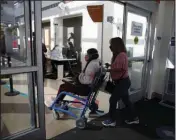  ?? (The New York Times/Jim Wilson) ?? A long covid patient is wheeled into a hospital by her mother in Sacramento, Calif., in October 2021.