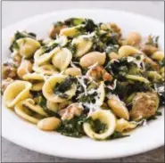  ?? JOE KELLER — AMERICA’S TEST KITCHEN VIA AP ?? This undated photo provided by America’s Test Kitchen in September 2018 shows pasta with sausage, kale and white beans in Brookline, Mass. This recipe appears in the cookbook “One-Pan Wonders.”