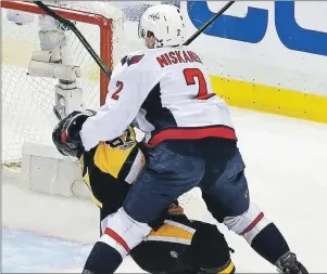  ?? THE ASSOCIATED PRESS ?? Pittsburgh Penguins’ Sidney Crosby (87) takes a hit from Washington Capitals’ Matt Niskanen during the first period of Game 3 in an NHL Stanley Cup Eastern Conference semifinal hockey game against the Washington Capitals in Pittsburgh, Monday, May 1.