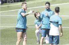  ?? — AFP photo ?? Real Madrid’s Sergio Ramos (left) and Isco (second right) attend a training session in Madrid.