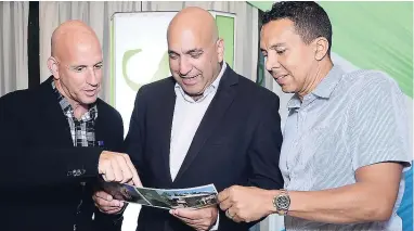  ??  ?? Gary Matalon (left) Christophe­r Zacca and David Shirley (right) checking out the Sagicor Property Services viewing portfolio.