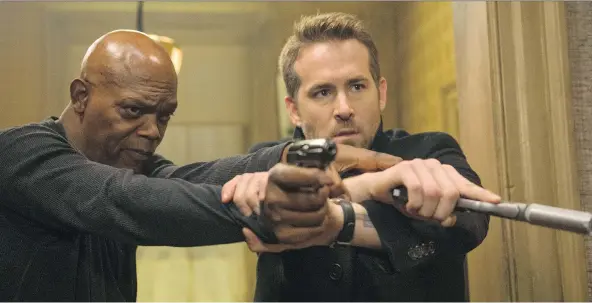  ?? JACK ENGLISH/LIONSGATE VIA AP ?? The Hitman’s Bodyguard from Lions Gate Entertainm­ent Corp., starring Samuel L. Jackson, left, and Ryan Reynolds, led the U.S. box office for a third time, generating US$13.4 million through Monday. The holiday weekend generated about US$99.5 million in...