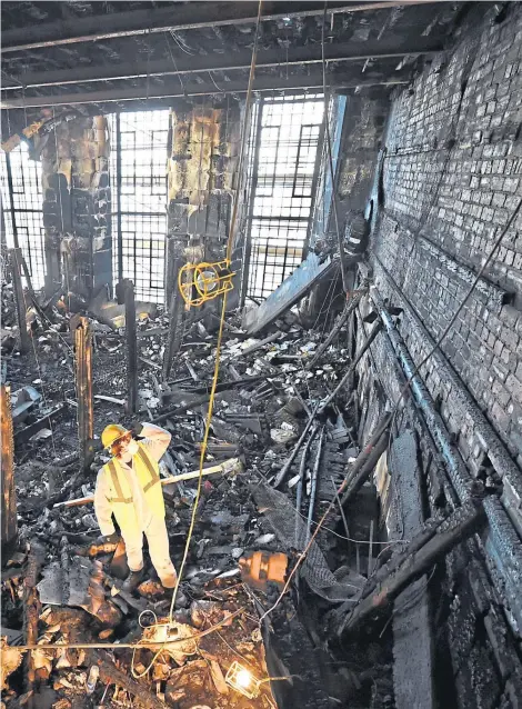  ?? ?? Forensic experts sift through the ashes of the library after the first blaze at Glasgow School of Art in 2014 and, right, the stunning interior where Liz Lochhead wrote her first poems in all its glory