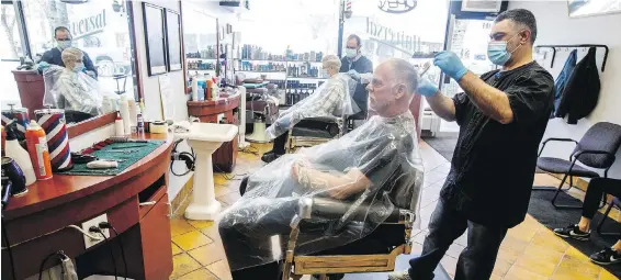  ??  ?? Top: A grounds crew prepares to open up Piper’s Heath Golf Club in Milton, Ont. Ontarians will be able to go shopping, play golf or tennis, and get their dogs groomed — but not visit family — starting next week as the province begins Stage 1 of its reopening. Above: Customers get their hair cut by barbers Billy Salla, right, and Ted Alkadri at Universal Barber Shop in Edmonton.