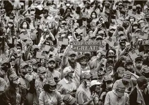  ?? Samuel Corum / Getty Images ?? Supporters, many wearing masks but some without, cheer as they wait for Trump to address the rally. The president plans to leave the White House this week for campaign events.