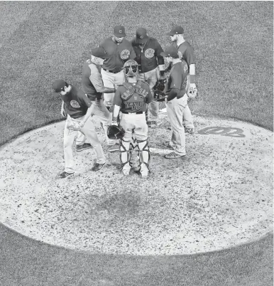  ?? ROB CARR, GETTY IMAGES ?? Cubs players and manager Joe Maddon gather to bid farewell to reliever Koji Uehara, one of eight pitchers Chicago used in a 3-hour, 54-minute win at the Nationals on Monday.