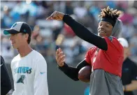  ?? AP Photo/Chuck Burton ?? ■ Carolina Panthers quarterbac­k Cam Newton, right, jokes with head trainer Ryan Vermillion, left, during practice at the team’s training camp Thursday in Spartanbur­g, N.C.