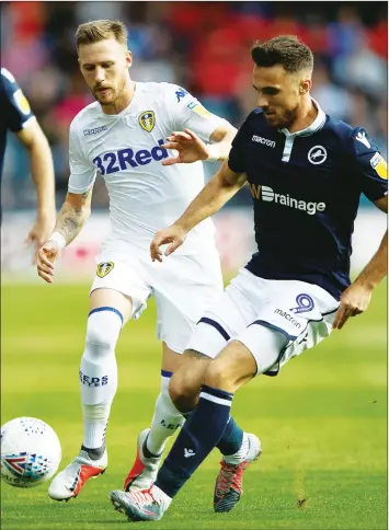  ??  ?? TUSSLE: Millwall’s Lee Gregory lays the ball off under pressure from Leeds’ Barry Douglas