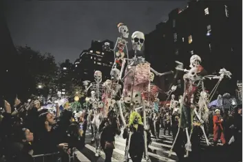  ?? FranK FranKLIn II/ AP PHOTO ?? REVELERS MARCH during the Greenwich Village Halloween Parade in New York on Oct. 31, 2019. The holiday so many look forward to each year is going to look different in the pandemic as parents and the people who provide Halloween fun navigate a myriad of restrictio­ns and safety concerns.