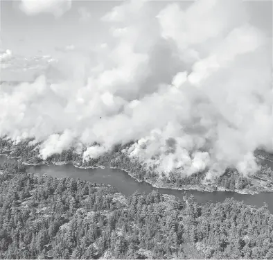  ?? DAN LEONARD / RESPONSE SPECIALIST / AFFES IGNITION / THE CANADIAN PRESS ?? An aerial view shows the extent of Parry Sound 33 fire being fought in Ontario by firefighte­rs from across Canada, the United States and Mexico. The wildfire could force the closure of a stretch of the Trans-canada Highway.