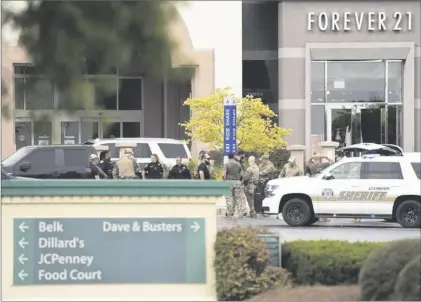  ?? AP PHOTO/SEAN RAYFORD ?? Members of law enforcemen­t gather outside Columbiana Centre mall in Columbia, S.C., ing a shooting, on April 16.
follow