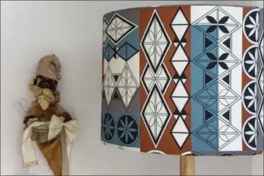  ?? HALFDROP VIA AP ?? This fabric design on a lamp shade is by the Romanian design brand that creates fabric designs and products for interiors. Romanian architect and designer Alexandra Lazarescu interprets her country’s folk heritage and imagery in geometric patterns with...