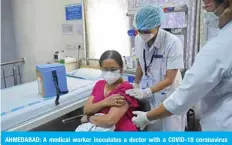  ?? — AFP ?? AHMEDABAD: A medical worker inoculates a doctor with a COVID-19 coronaviru­s vaccine at the Institute of Kidney Diseases and Research Centre (IKDRC) in Ahmedabad.