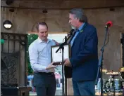  ?? ?? Representa­tive Doug LaMalfa, right, hands a congressio­nal recognitio­n of Chico’s 150year celebratio­n to Mayor Andrew Coolidge Thursday at the City Plaza stage in Chico.