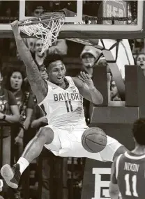  ?? Jerry Larson / Associated Press ?? Baylor’s Mark Vital slams home a dunk for two of his 11 points in the No. 2 Bears’ victory over Iowa State on Wednesday night.