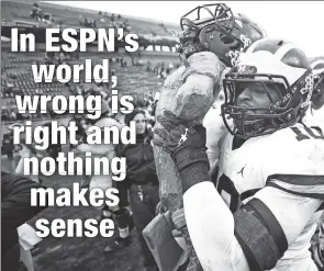  ?? Getty Images ?? BUSH LEAGUE: Michigan linebacker Devin Bush carries off the Paul Bunyan trophy after his team beat Michigan State on Saturday, hours after Bush had defaced the Spartans’ field logo following a fight between the teams.