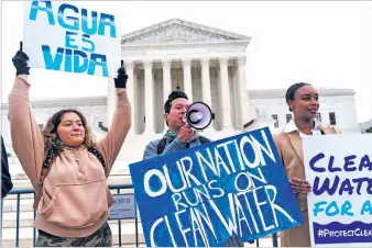  ?? JACQUELYN MARTIN/ASSOCIATED PRESS FILE PHOTO ?? From left, Bethsaida Sigaran of Baltimore; her brother, Jaime Sigaran, with American Rivers; and Thea Louis, with Clean Water Action, demonstrat­e in October outside the Supreme Court.