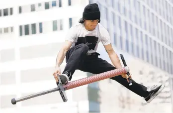  ?? TIM TAI/AP ?? Nicolas Patino, an extreme pogo competitor, demonstrat­es a trick Dec. 3 at Thomas Paine Plaza in Center City Philadelph­ia.