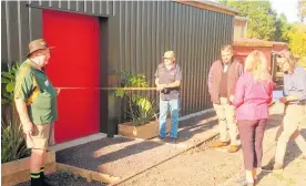  ?? Photo / Anne Leitch ?? Sue Hamnett, representi­ng BOIVR & NAX preparing to cut the ribbon held by Denis Hewitt and Henry Nissen. Blessing is overseen by Huru Tipene.