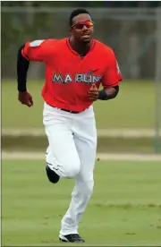  ?? File, Jeff Roberson / AP ?? Miami Marlins outfielder Lewis Brinson runs sprints during spring training practice.