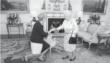  ?? Photo: AFP ?? Britain's new Prime Minister Theresa May (left) kneels as she is greeted by Britain's Queen Elizabeth II (right) at the start of an audience in Buckingham Palace in central London yesterday.