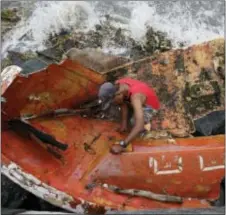  ?? AARON FAVILA — THE ASSOCIATED PRESS ?? Filipino Joybin Marayo, 58, salvages metals on a damaged boat that was washed ashore by strong waves brought about by Typhoon Haima in Manila, Philippine­s on Thursday.