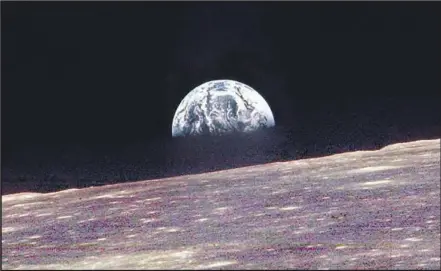  ?? Bill Anders NASA ?? EARTH rises over the horizon of the moon on Dec. 24, 1968. The photo by an Apollo 8 astronaut inspired millions after a violent year.