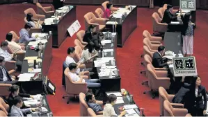  ??  ?? Members of the ruling Democratic Progressiv­e Party hold signs that read “agree” during a parliament­ary vote on draft bills of a same-sex marriage law in Taipei in May 2019. Forty-two percent of Taiwan’s 113 legislator­s are women, the highest rate of female representa­tion in Asia.