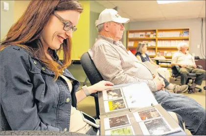  ?? MILLICENT MCKAY/JOURNAL PIONEER ?? Nikki Gallant looks at picture of her father, Tilman Gallant, which was taken while he was working on one of the Marine Atlantic Ferries.