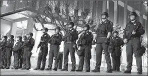  ?? AP/BEN MARGOT ?? Police officers stand guard Feb. 1 at the University of California, Berkeley, outside the building where right-wing writer Milo Yiannopoul­os was scheduled to speak, before a violent outbreak forced the cancellati­on of his event.