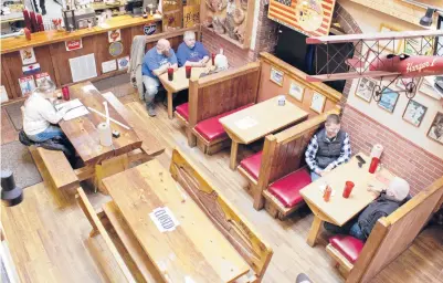  ?? FLACCUS/AP GILLIAN ?? Diners grab a bite to eat Jan. 6 at the Carver Hangar, a family-owned restaurant and sports bar in Boring, Oregon. The National Restaurant Associatio­n said that in January industrywi­de revenue was down more than 16% from a year earlier.